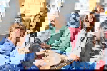 Kvinna sitter på tåget med sin dator och jobbar